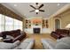 Spacious living room with built-in shelving, fireplace, plush seating, and natural light at 1017 Payton Ct, Raleigh, NC 27614