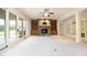 Spacious living room with stone fireplace, built-in shelving, and access to an outdoor patio at 1017 Payton Ct, Raleigh, NC 27614