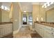 Luxurious main bathroom with dual vanities, granite countertops, and a soaking tub at 1017 Payton Ct, Raleigh, NC 27614