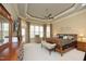 Spacious main bedroom suite with tray ceilings, a ceiling fan, and large windows at 1017 Payton Ct, Raleigh, NC 27614
