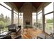 Relaxing screened porch with brick fireplace and comfortable seating area at 1017 Payton Ct, Raleigh, NC 27614