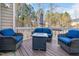 Covered porch with comfortable wicker furniture and an umbrella, ideal for relaxing outdoors at 104 Spooner Ct, Holly Springs, NC 27540