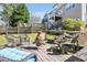 Scenic backyard featuring a patio area with fire pit, seating, and landscaped garden beds at 104 Spooner Ct, Holly Springs, NC 27540