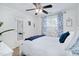 Bright bedroom featuring a ceiling fan, white bedding, and stylish blue patterned curtains at 104 Spooner Ct, Holly Springs, NC 27540