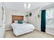 Inviting bedroom with a wood headboard, a chandelier, and a window with curtains at 104 Spooner Ct, Holly Springs, NC 27540