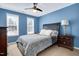Inviting bedroom with blue walls, cozy furniture, large windows, and a comfortable bed at 104 Spooner Ct, Holly Springs, NC 27540