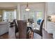 Cozy dining area features a glass-top table, brown leather chairs, and access to the outdoor deck at 104 Spooner Ct, Holly Springs, NC 27540