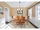 Dining room features wood table, chairs, chandelier, and natural light at 104 Spooner Ct, Holly Springs, NC 27540