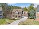 Charming two-story home with a welcoming front porch and well-manicured lawn in a leafy neighborhood at 104 Spooner Ct, Holly Springs, NC 27540