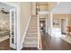 Spacious foyer with hardwood floors, staircase, and views to living areas at 104 Spooner Ct, Holly Springs, NC 27540