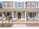 Welcoming front porch with rocking chairs, a swing, and a decorative wreath provides great curb appeal at 104 Spooner Ct, Holly Springs, NC 27540