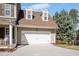 Attached two-car garage offers convenience and ample space for parking and storage, with a clean driveway at 104 Spooner Ct, Holly Springs, NC 27540