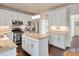 Well-equipped kitchen with granite counters, stainless appliances, and an island at 104 Spooner Ct, Holly Springs, NC 27540