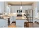 Bright kitchen featuring granite countertops, stainless appliances, and a breakfast bar at 104 Spooner Ct, Holly Springs, NC 27540