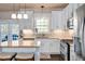 Updated kitchen features stainless steel appliances, granite countertops, and white cabinetry at 104 Spooner Ct, Holly Springs, NC 27540