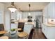 Modern kitchen with stainless appliances, white cabinets, granite counters, and breakfast area at 104 Spooner Ct, Holly Springs, NC 27540