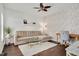 Cozy living room with brick accent wall, wood floors, and neutral decor at 104 Spooner Ct, Holly Springs, NC 27540