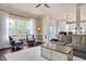 Bright and airy living room with large windows, comfortable armchairs and view of the outdoor space at 104 Spooner Ct, Holly Springs, NC 27540