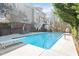 Backyard features a refreshing in-ground pool, diving board, lounge chairs, and an upper-level deck at 104 Spooner Ct, Holly Springs, NC 27540