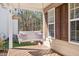 Cozy front porch swing with cushions offers a relaxing outdoor space for enjoying the views at 104 Spooner Ct, Holly Springs, NC 27540