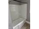 Clean bathtub with a shower head and shelving, ready for a relaxing bath or shower at 105 S Elizabeth St, Henderson, NC 27536