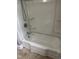 Clean bathtub with a shower head and shelving, ready for a relaxing bath or shower at 105 S Elizabeth St, Henderson, NC 27536