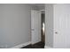 Bedroom with an open door, fresh paint, wood-look floors and white baseboards at 105 S Elizabeth St, Henderson, NC 27536