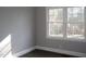 Corner of bright bedroom featuring wood-look floors, freshly painted walls and plenty of natural light at 105 S Elizabeth St, Henderson, NC 27536