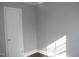 Bedroom with fresh paint, wood-look floors and a freshly painted white door at 105 S Elizabeth St, Henderson, NC 27536