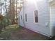 Side view of home with vinyl siding, windows, and a well-maintained yard at 105 S Elizabeth St, Henderson, NC 27536
