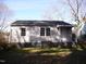 Exterior of home featuring vinyl siding and a small back porch at 105 S Elizabeth St, Henderson, NC 27536