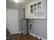 Kitchen showcasing ample cabinet space, overhead lighting, and water heater at 105 S Elizabeth St, Henderson, NC 27536