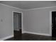 Open-concept living room with durable flooring, neutral walls, and generous entryway at 105 S Elizabeth St, Henderson, NC 27536