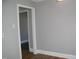 Open-concept living room with durable flooring, neutral walls, and generous doorways at 105 S Elizabeth St, Henderson, NC 27536