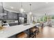 Open kitchen featuring a breakfast bar with stylish chairs and decor, flowing into the dining and living areas for seamless entertaining at 10529 Pleasant Branch Dr # 101, Raleigh, NC 27614