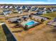 Aerial view showcases a community pool, parking, playground, and neighborhood at 109 Perignon Dr, Princeton, NC 27569