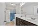 Bathroom featuring double sink vanity with dark cabinets and a shower with blue curtains at 109 Perignon Dr, Princeton, NC 27569