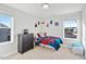 Bedroom featuring two windows, dark dresser, and a bed with a colorful comforter at 109 Perignon Dr, Princeton, NC 27569