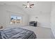 Bright bedroom with vaulted ceiling, ceiling fan, and large window offering neighborhood views at 109 Perignon Dr, Princeton, NC 27569