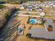 A high angle view of a community featuring a pool, playground, parking and neighboring homes with generous yards at 109 Perignon Dr, Princeton, NC 27569