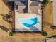 Aerial view of a gated community pool with chairs, landscaping and trees at 109 Perignon Dr, Princeton, NC 27569