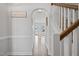 Bright foyer featuring hardwood floors, white trim, an arched doorway and a staircase with wooden banister at 109 Perignon Dr, Princeton, NC 27569