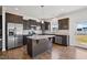 Modern kitchen features dark cabinetry, stainless steel appliances, granite countertops, and a central island at 109 Perignon Dr, Princeton, NC 27569