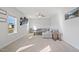 Bright living room with neutral carpet, white walls, a ceiling fan, a comfortable sectional sofa, and natural light at 109 Perignon Dr, Princeton, NC 27569