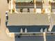 An aerial rooftop view of modern townhomes with an asphalt roof and an adjacent parking area at 1414 Excelsior Grand Ave, Durham, NC 27713