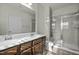 Bathroom featuring a double vanity and a glass-enclosed shower at 1414 Excelsior Grand Ave, Durham, NC 27713