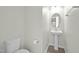Powder room with pedestal sink, oval mirror, and modern fixtures, perfect for guests at 1414 Excelsior Grand Ave, Durham, NC 27713