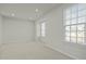 Bright bedroom with neutral tones, carpeted floor, recessed lights, and two large windows at 1414 Excelsior Grand Ave, Durham, NC 27713