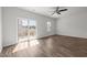 Bright bedroom featuring hardwood floors, a balcony, and abundant natural light at 1414 Excelsior Grand Ave, Durham, NC 27713