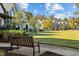 Well-maintained common area featuring a bench, lush green lawn, and beautiful landscaping at 1414 Excelsior Grand Ave, Durham, NC 27713
